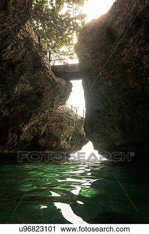 Stock Image - Jamaica, Negril, Footbridge hanging between rocks. Fotosearch