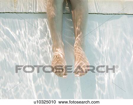 Stock Image - Legs of girl (4-5) underwater. Fotosearch