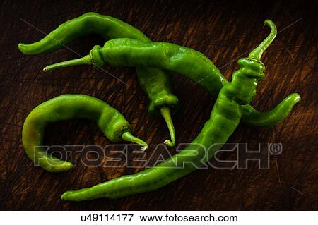 Long hot peppers on wooden table View Large Photo Image Stock Photo - Long hot peppers on wooden table. Fotosearch