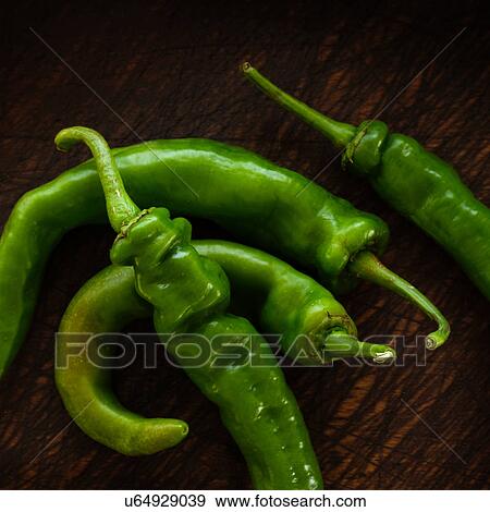 Stock Photo - Long hot peppers on wooden table. Fotosearch