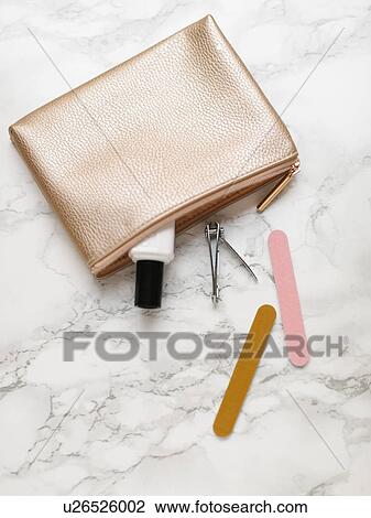 Stock Image - Manicure accessories and purse on marble background. Fotosearch