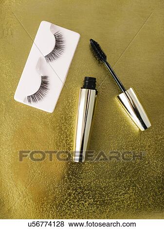 Stock Photo - Mascara and false eyelashes on shiny background. Fotosearch