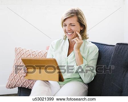 Mature woman using tablet View Large Photo Image Stock Photo - Mature woman using tablet. Fotosearch