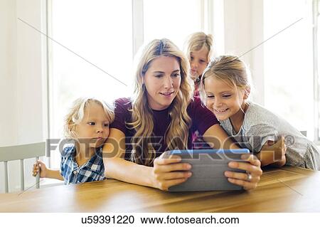Mother and children (4-5, 6-7, 8-9) with digital tablet View Large Photo Image Stock Image - Mother and children (4-5, 6-7, 8-9) with digital tablet. Fotosearch