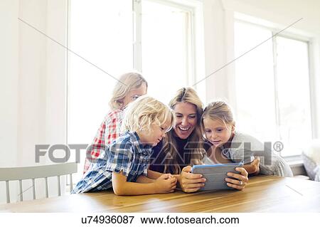 Mother and children (4-5, 6-7, 8-9) with digital tablet View Large Photo Image Stock Photo - Mother and children (4-5, 6-7, 8-9) with digital tablet. Fotosearch