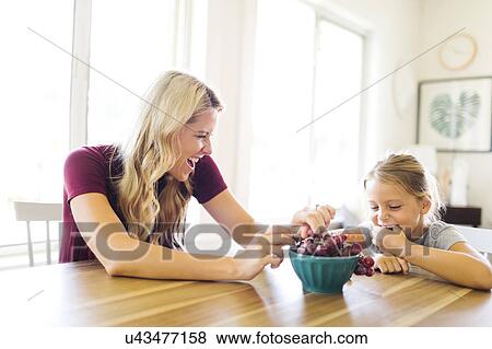 Mother and daughter (6-7) eating grapes View Large Photo Image Stock Photo - Mother and daughter (6-7) eating grapes. Fotosearch