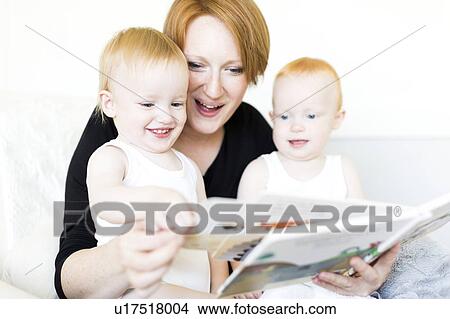 Mother and sons (12-17 months) reading picture book View Large Photo Image Picture - Mother and sons (12-17 months) reading picture book. Fotosearch