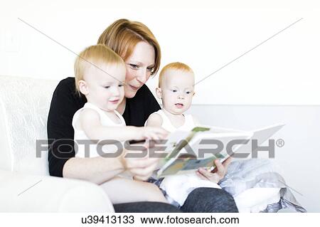 Mother and sons (12-17 months) reading picture book View Large Photo Image Stock Image - Mother and sons (12-17 months) reading picture book. Fotosearch