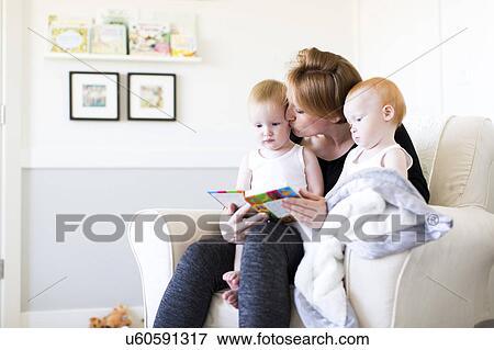 Mother and sons (12-17 months) reading picture book View Large Photo Image Stock Photo - Mother and sons (12-17 months) reading picture book. Fotosearch