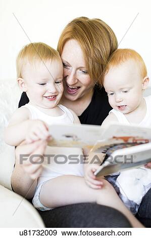 Mother and sons (12-17 months) reading picture book View Large Photo Image Stock Photo - Mother and sons (12-17 months) reading picture book. Fotosearch