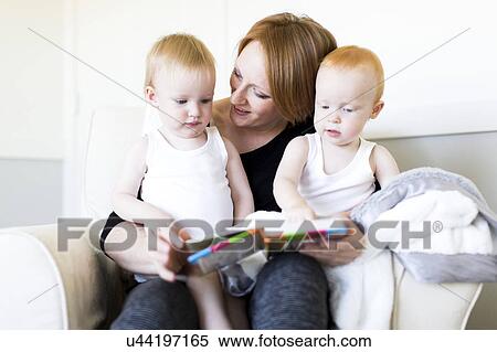 Mother and sons (12-17 months) reading picture book View Large Photo Image Stock Photography - Mother and sons (12-17 months) reading picture book. Fotosearch