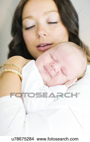 Mother carrying daughter (0-1 months) View Large Photo Image Picture - Mother carrying daughter (0-1 months). Fotosearch