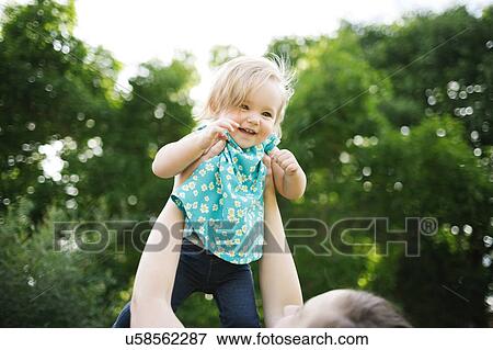 Mother carrying daughter (12-17 months) View Large Photo Image Stock Photo - Mother carrying daughter (12-17 months). Fotosearch