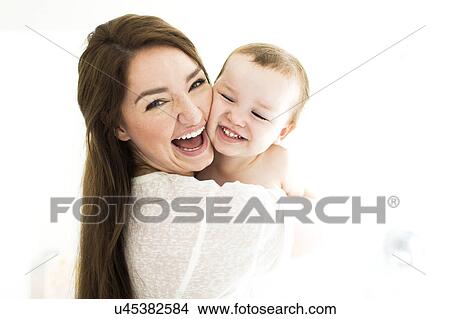 Mother carrying son (4-5) and laughing View Large Photo Image Picture - Mother carrying son (4-5) and laughing. Fotosearch
