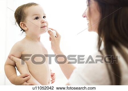 Mother cleaning son (4-5) face View Large Photo Image Stock Image - Mother cleaning son (4-5) face. Fotosearch