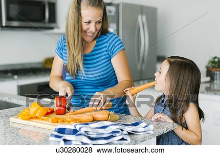 Mother cooking with daughter (6-7) in kitchen View Large Photo Image Stock Photo - Mother cooking with daughter (6-7) in kitchen. Fotosearch