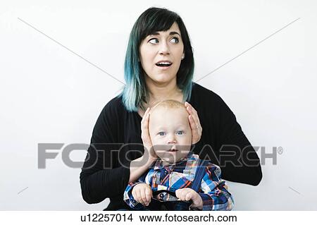 Mother covering son's ears (12-17 months) View Large Photo Image Picture - Mother covering son's ears (12-17 months). Fotosearch