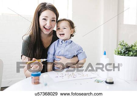 Stock Photo - Mother drawing with son (4-5). Fotosearch