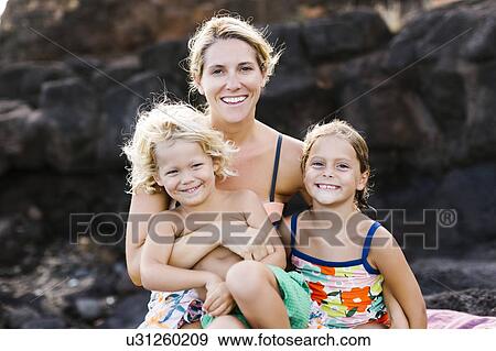 Stock Photo - Mother embracing kids (4-5, 6-7). Fotosearch