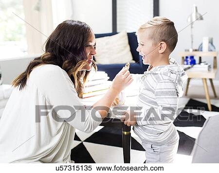 Mother giving son (4-5) cookie View Large Photo Image Stock Photography - Mother giving son (4-5) cookie. Fotosearch