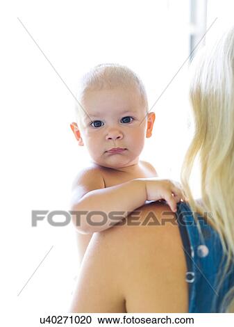Stock Image - Mother holding baby boy (18-23 months). Fotosearch