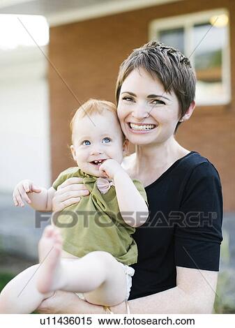 Stock Photography - Mother holding daughter (12-17). Fotosearch