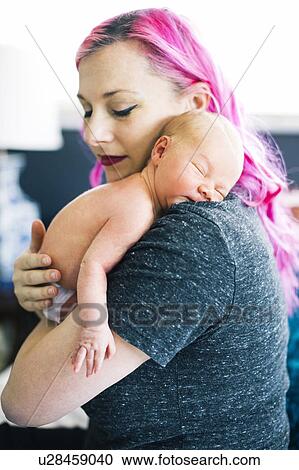 Stock Image - Mother holding newborn son (2-5 months). Fotosearch