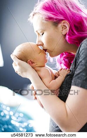 Stock Image - Mother holding newborn son (2-5 months). Fotosearch