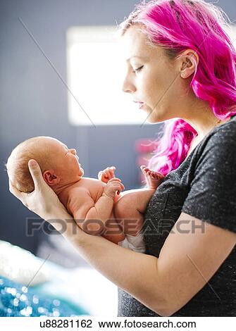 Mother holding newborn son (2-5 months) View Large Photo Image Stock Image - Mother holding newborn son (2-5 months). Fotosearch