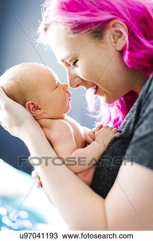 Mother holding newborn son (2-5 months) View Large Photo Image Stock Image - Mother holding newborn son (2-5 months). Fotosearch