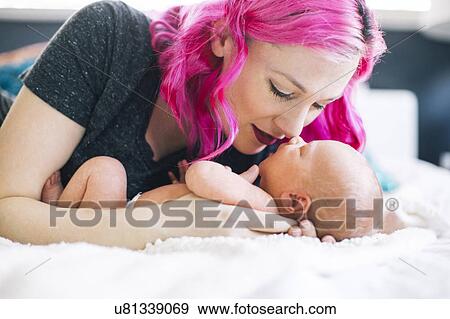 Mother holding newborn son (2-5 months) View Large Photo Image Stock Photo - Mother holding newborn son (2-5 months). Fotosearch