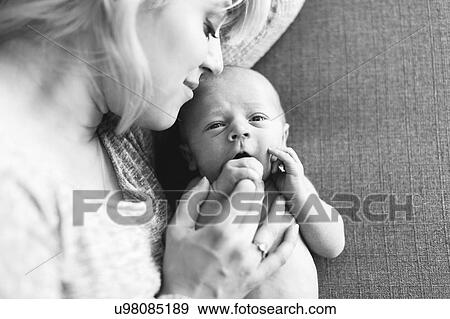 Mother holding one day son (0-1 months) View Large Photo Image Stock Photo - Mother holding one day son (0-1 months). Fotosearch