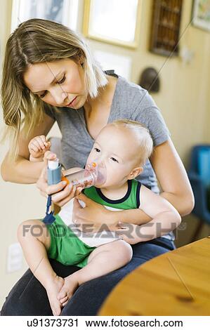 Stock Image - Mother inhaling son (12-17 months). Fotosearch
