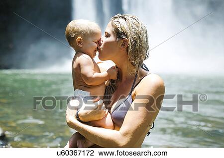 Mother kissing baby (18-23 months) with love View Large Photo Image Stock Image - Mother kissing baby (18-23 months) with love. Fotosearch