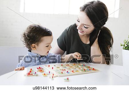 Mother playing alphabet game with son (4-5) View Large Photo Image Stock Image - Mother playing alphabet game with son (4-5). Fotosearch