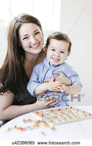 Mother playing alphabet game with son (4-5) View Large Photo Image Stock Photography - Mother playing alphabet game with son (4-5). Fotosearch