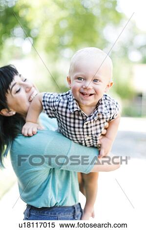 Stock Photography - Mother playing with baby boy (12-17 months). Fotosearch