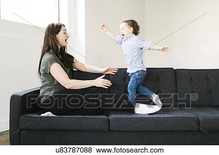 Stock Photo - Mother playing with son (4-5). Fotosearch