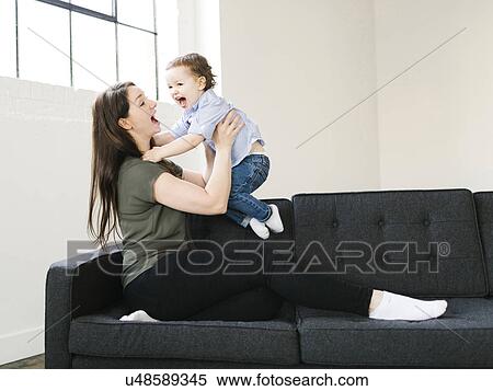 Stock Photography - Mother playing with son (4-5). Fotosearch