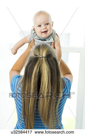 Mother playing with son (6-11 months) View Large Photo Image Stock Photo - Mother playing with son (6-11 months). Fotosearch