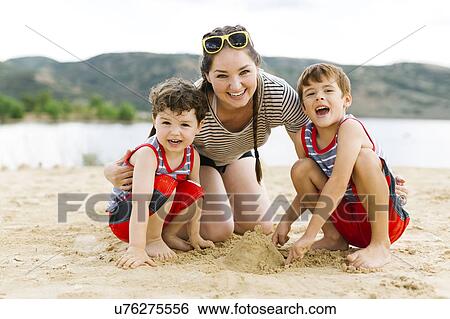 Mother playing with sons (4-5, 6-7) on beach by lake View Large Photo Image Stock Photograph - Mother playing with sons (4-5, 6-7) on beach by lake. Fotosearch