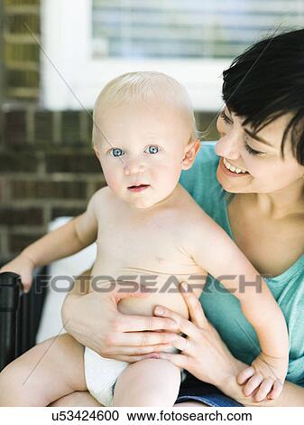 Mother sitting with baby boy (12-17 months) on porch View Large Photo Image Stock Image - Mother sitting with baby boy (12-17 months) on porch. Fotosearch