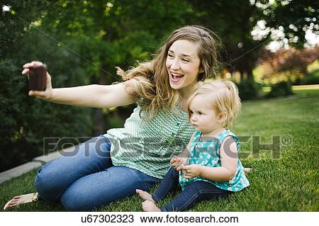 Mother taking selfie with daughter (12-17 months) View Large Photo Image Stock Image - Mother taking selfie with daughter (12-17 months). Fotosearch