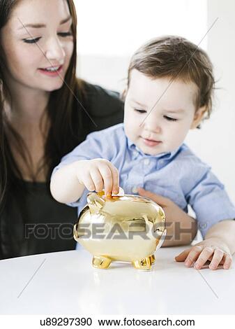 Mother teaching son (4-5) how to save money View Large Photo Image Stock Image - Mother teaching son (4-5) how to save money. Fotosearch