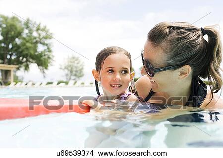 Mother with daughter (4-5) in swimming pool View Large Photo Image Picture - Mother with daughter (4-5) in swimming pool. Fotosearch