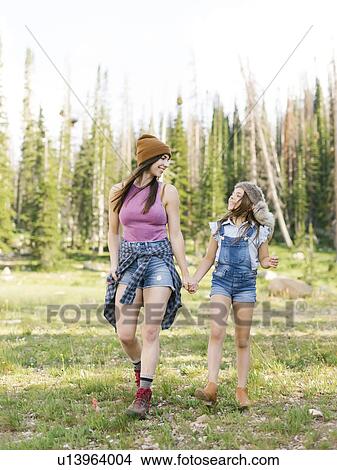 Picture - Mother with daughter (8-9) hiking in forest. Fotosearch