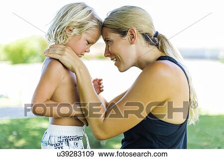 Stock Photo - Mother with son (4-5) embracing. Fotosearch