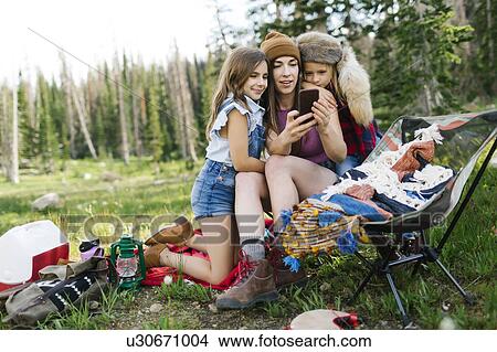 Mother with son (6-7) and daughter (8-9) camping in forest View Large Photo Image Picture - Mother with son (6-7) and daughter (8-9) camping in forest. Fotosearch