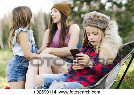 Picture - Mother with son (6-7) and daughter (8-9) camping in forest. Fotosearch