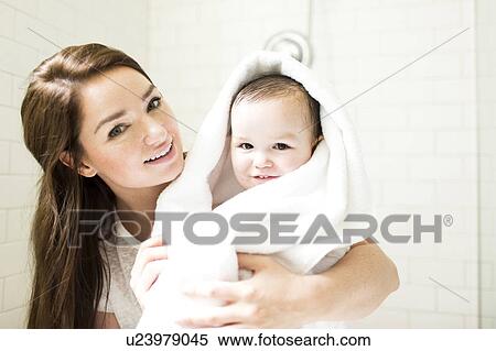 Mother wrapping son (4-5) in towel in bathroom View Large Photo Image Stock Photography - Mother wrapping son (4-5) in towel in bathroom. Fotosearch